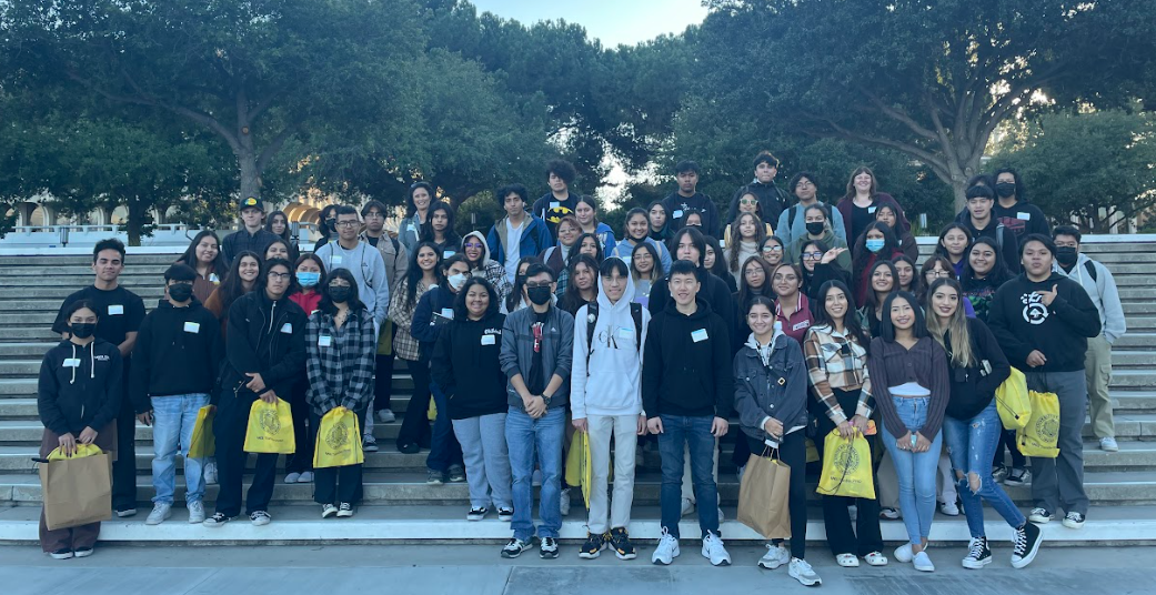 SAC ULink students pose during their UCI campus visit on some stairs.